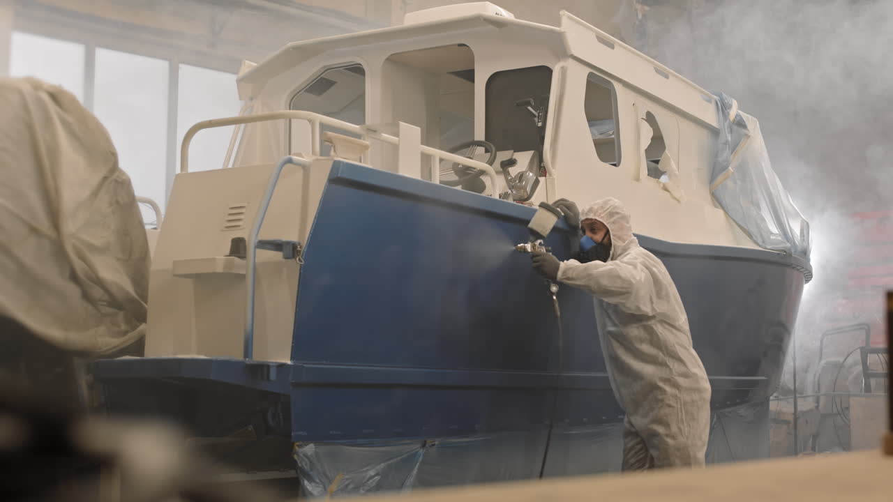 Workman Using Airbrush on Boat