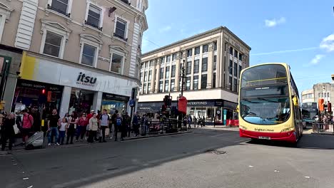 buses and cars navigate busy brighton street