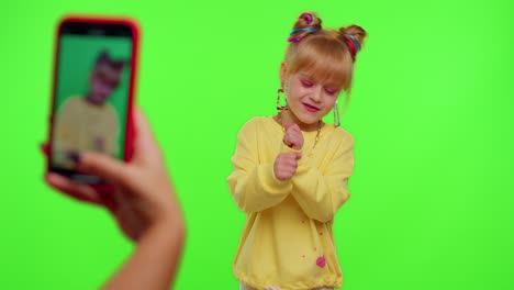 Dancing-young-little-kid-girl-blogger-record-dance-moves-at-camera-for-social-media-content-on-phone