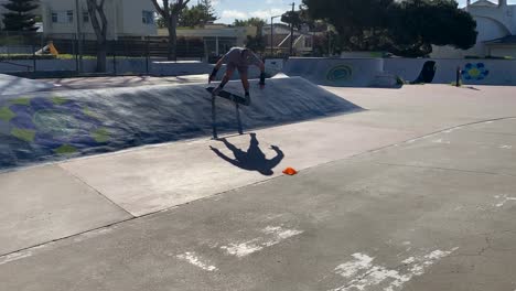 caucasian man skateboarding on the ramps on sunny day