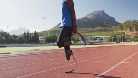 disabled mixed race man with prosthetic legs stretching