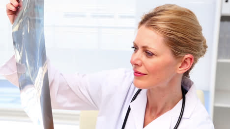 Doctor-looking-at-xray-at-her-desk