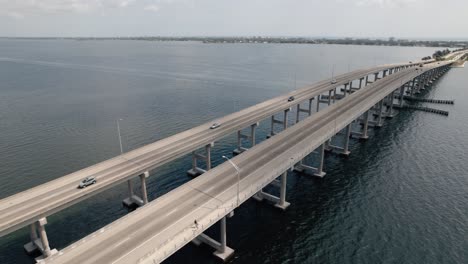 aerial shot flying over traffic on a coastal causeway in melbourne florida