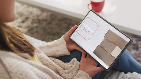 caucasian woman using tablet at home online shopping on cyber monday sale day, slow motion