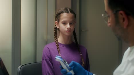 doctor examining a child's temperature