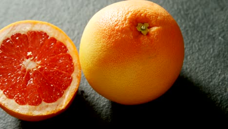 grapefruit with half grapefruit on grey background 4k 4k