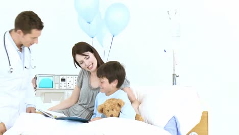 doctor taking little boys pulse in hospital