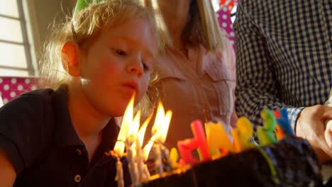 close-up of son blowing out birthday candles 4k