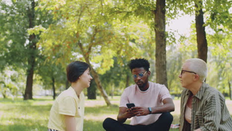 multiethnic college students and teacher talking in park