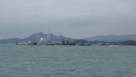 view from the water of industrial shipping and fishing boats