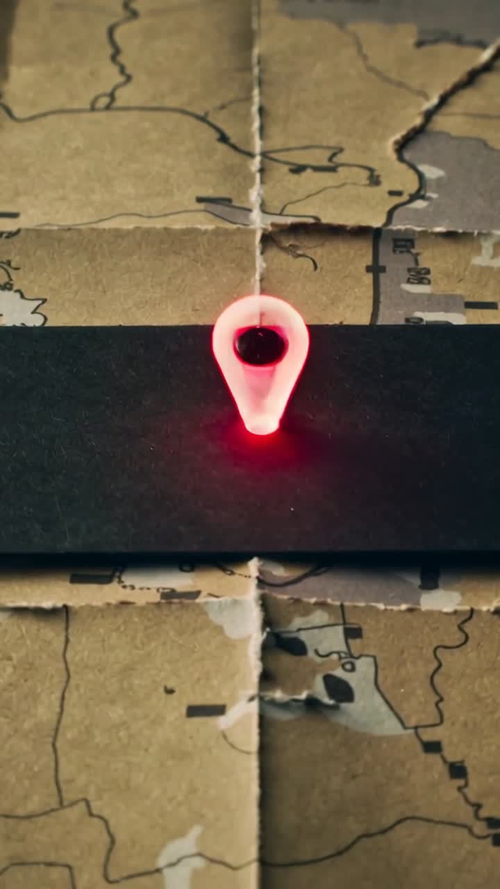 Vertical video: Lighting at start, translucent red locator pin pulsing on black strip, marking map