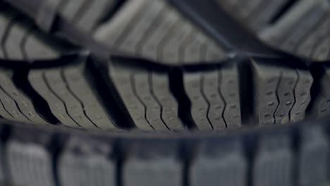 many new winter tires on shelves and in columns. panorama of the store.