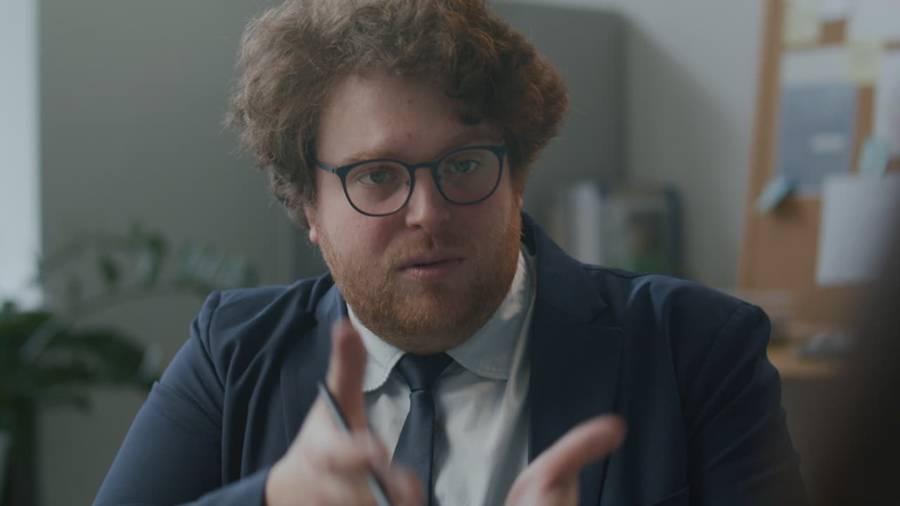 Manager Explaining Business Tasks to Employee during Office Meeting