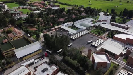 Toma-Aérea-De-Un-Dron-Orbital-De-La-Estación-Terminal-De-Autobuses-Con-Autobuses-Estacionados-Y-Saliendo