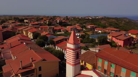 Aerial-view-of-bell-tower-in-Tresnuraghes,-Sardinia,-circle-pan,-day