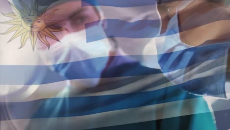 animation of flag of uruguay waving over surgeons in operating theatre