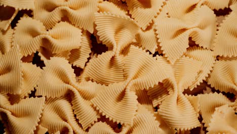 a pile of uncooked butterfly pasta on a wooden table