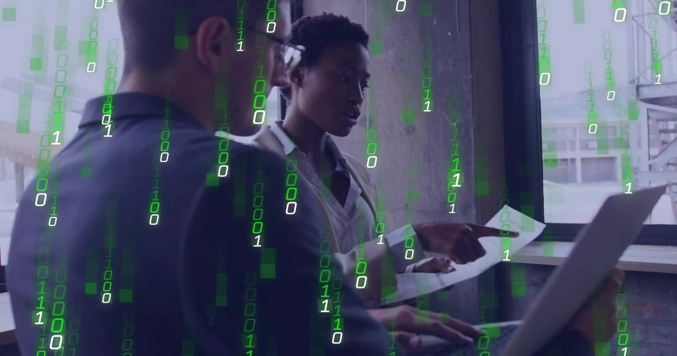 Vertical video: She pointing at docs, he typing on laptop as binary overlay growing, reviewing data