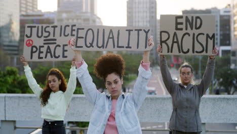 shot of a three young women protesting outside