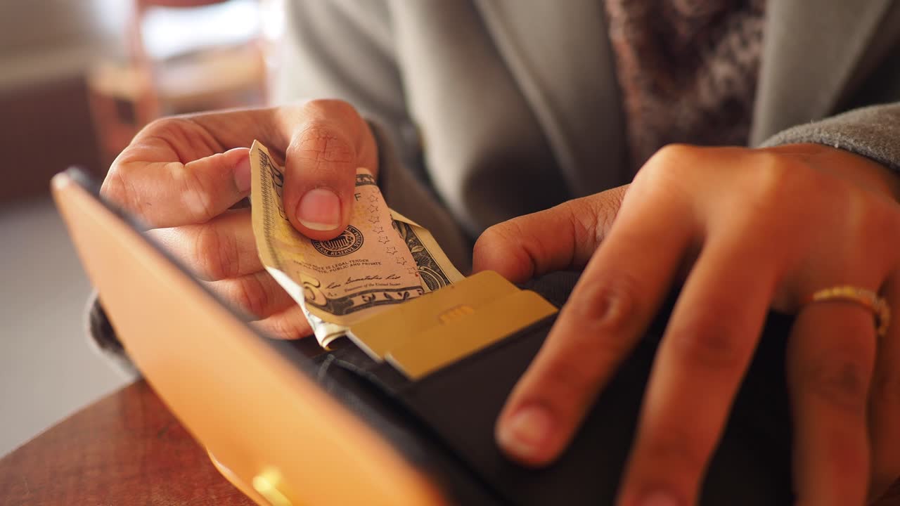 Woman taking a credit card from her wallet