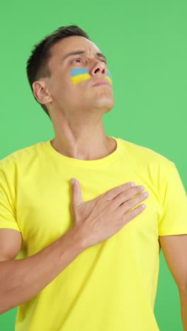 ukrainian patriot listening to the national anthem with solemnity