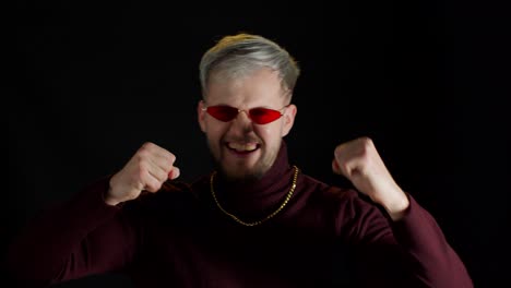 Funny-stylish-man-in-red-sunglasses-dancing-fooling-around-having-fun-expressive-gesticulating-hands