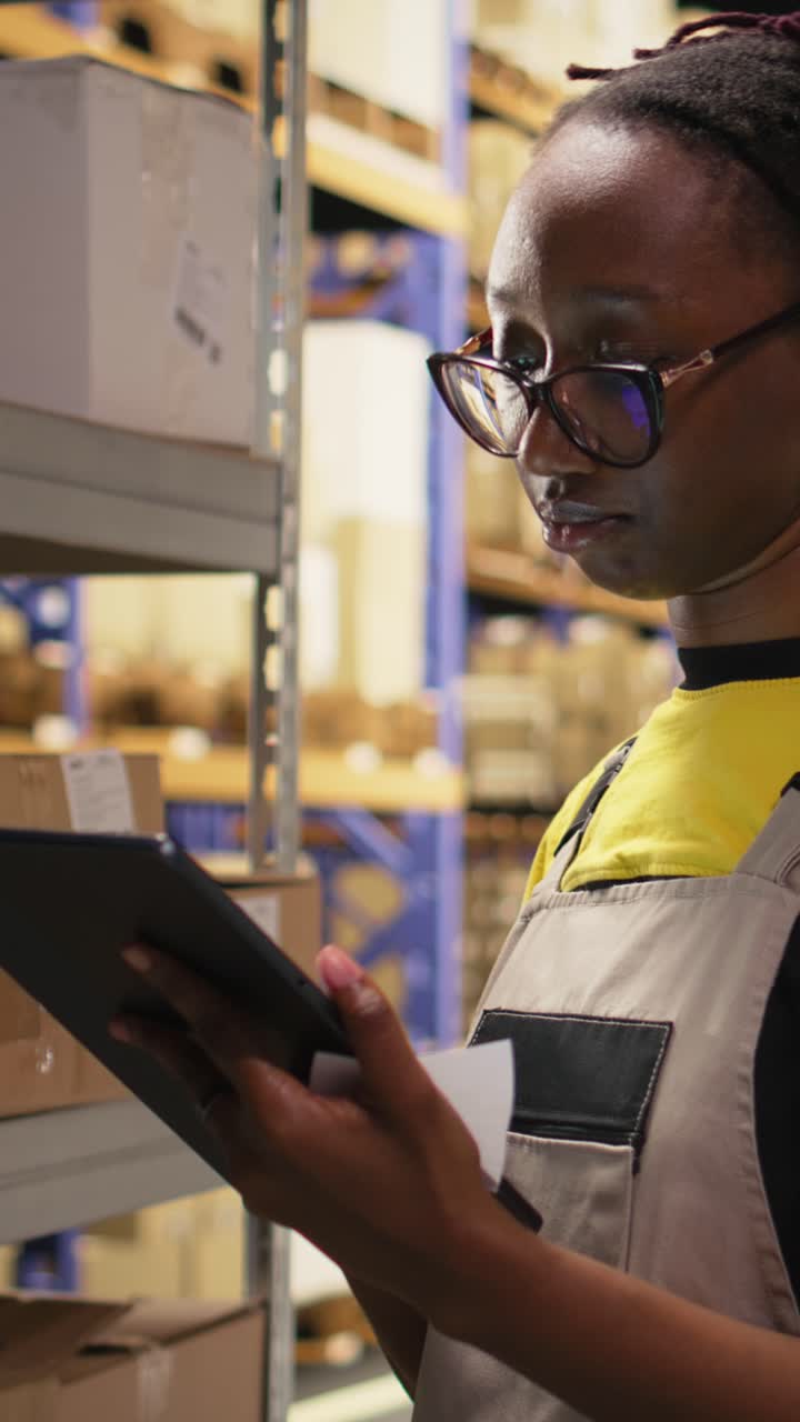 Vertical Video African american employee applies shipping labels tags on cargo boxes