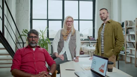 team of diverse colleagues posing for camera in modern office