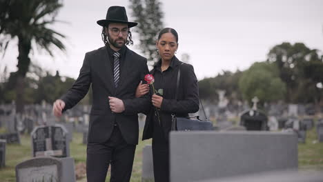 sad, couple and mourning at tomb of cemetery