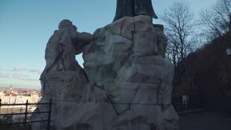 rear view of saint gellert monument situated at gellert hill in budapest hungary - tilt up pan shot