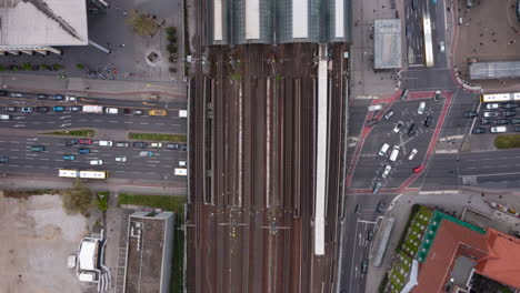 Aerial-birds-eye-overhead-top-down-view-of-traffic-on-intersection-in-rush-hour.-Wide-multi-track-railway-bridge-at-Berlin-Spandau-train-station.-Hyperlapse-of-transport-in-city