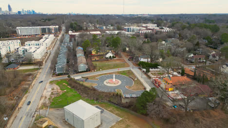 aerial birds eye shot of car on road in suburb area of atlanta city with skyline in background