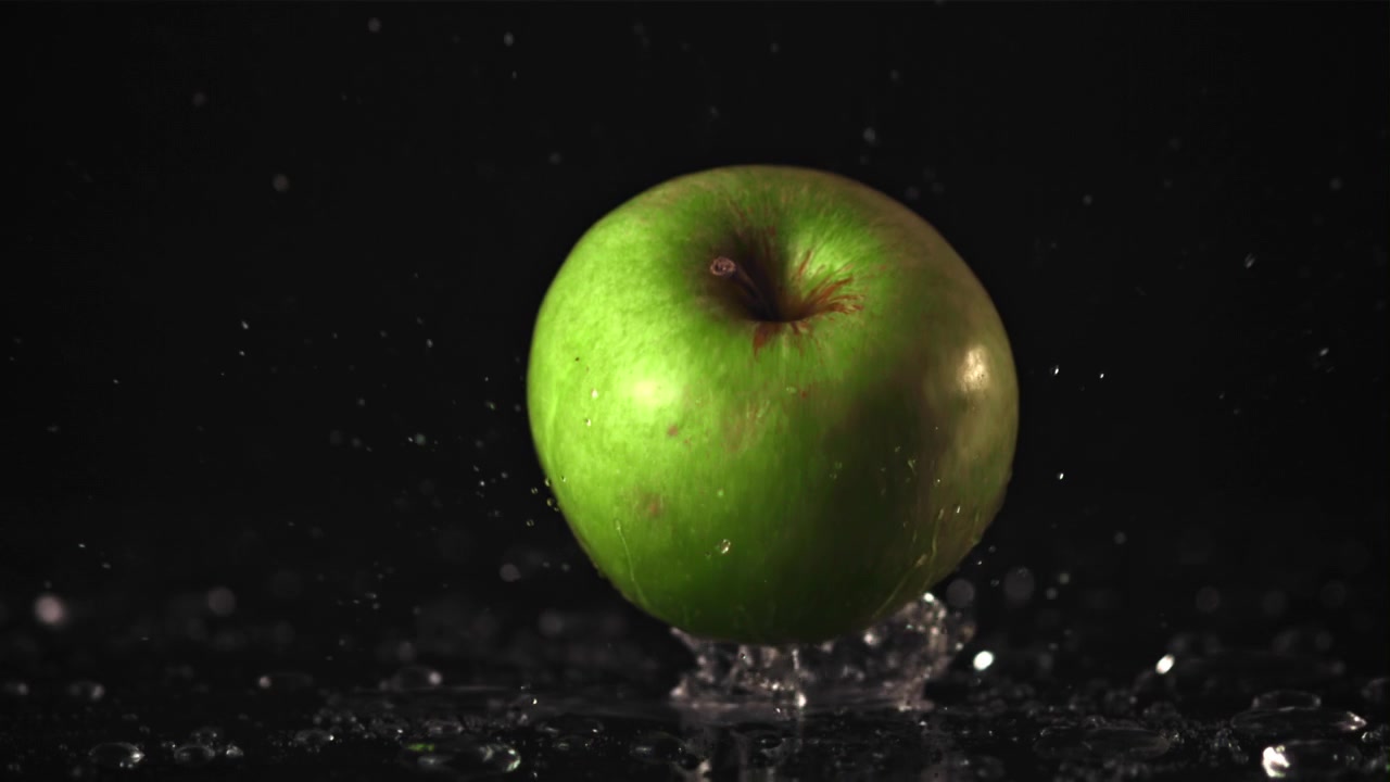 Grønt Æble Falder i Vand med Plask i Slowmotion.