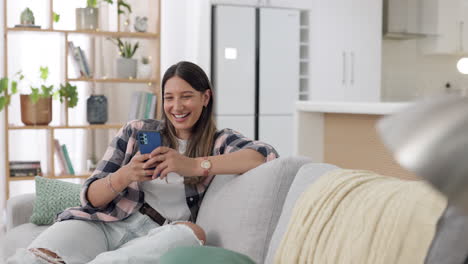 Phone,-social-media-and-a-woman-laughing-on-a-sofa