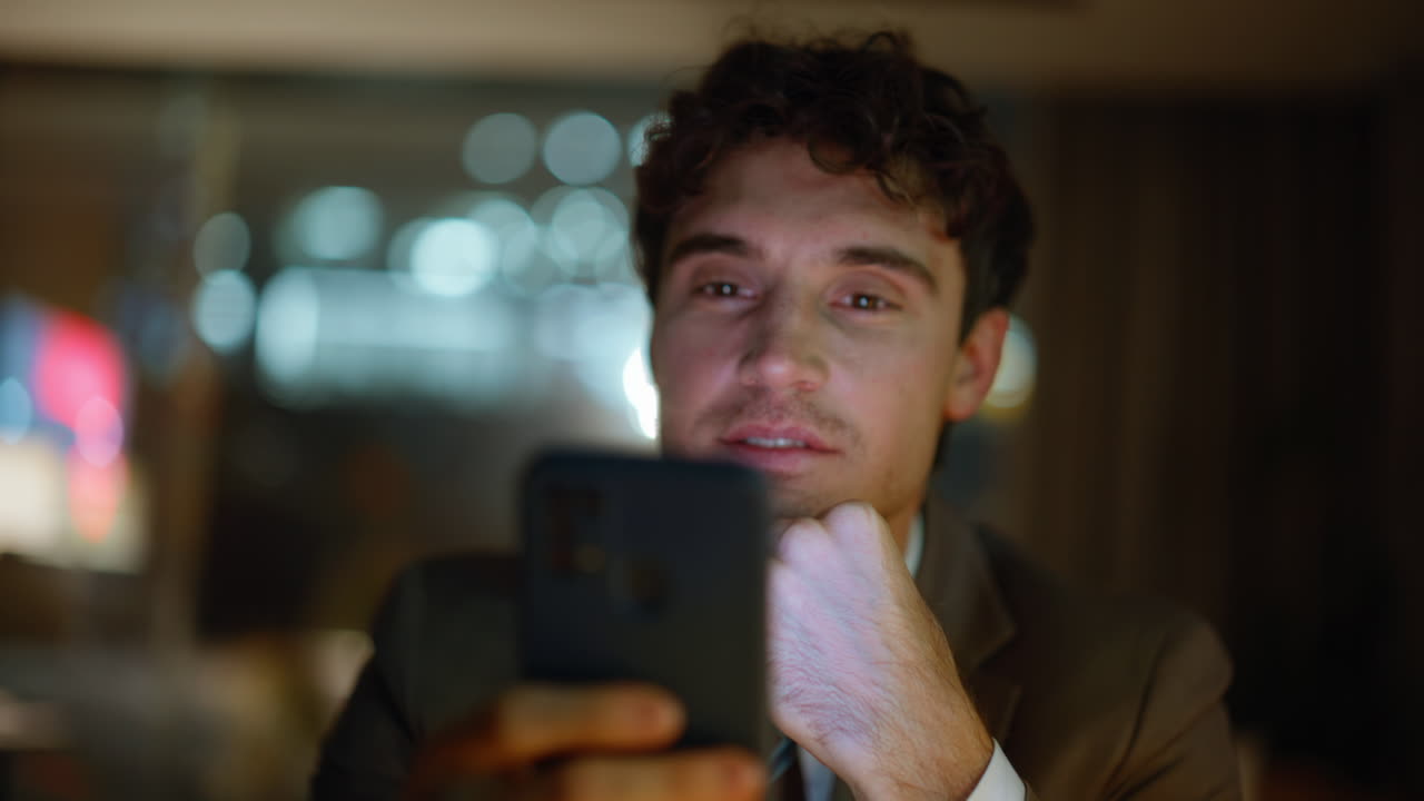 Businessman receiving message night office feeling satisfied alone portrait