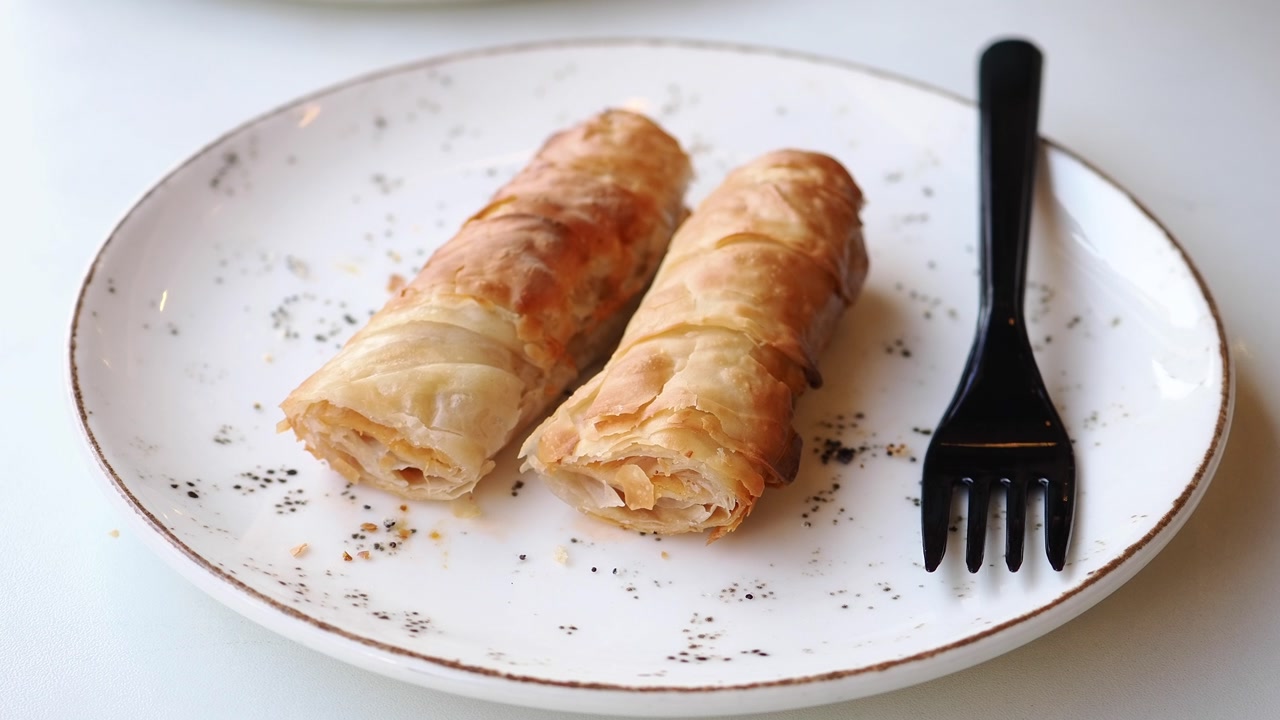 Crispy Golden Pastry Rolls Served on a White Plate