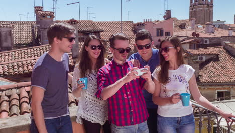 friends taking selfies on a rooftop in venice