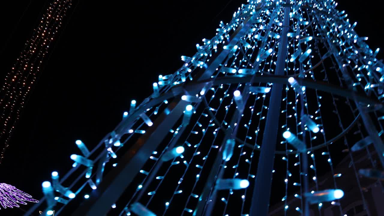 Christmas lights on a city avenue in Portugal street level handheld shot