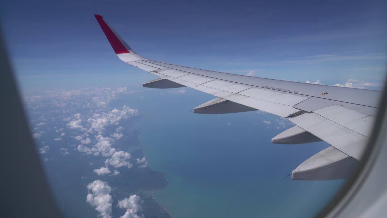 Clouds and sky as seen through window of an aircraft