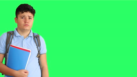 sad schoolboy with medical mask at green screen