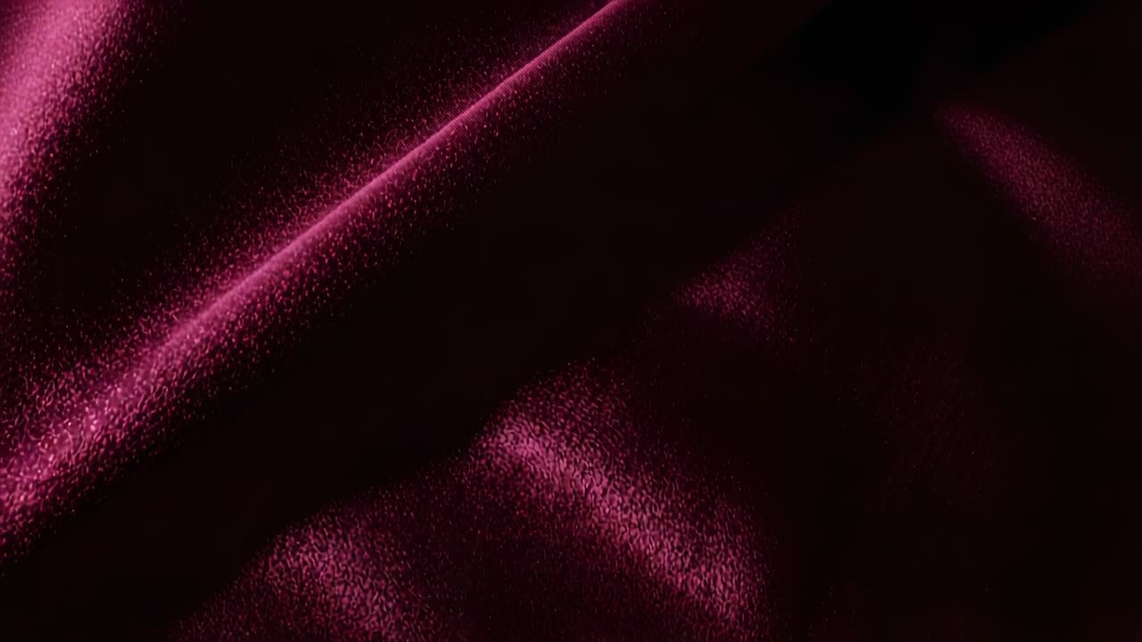 Luz direccional cambiante que revela una tela de terciopelo burdeos mostrando la textura del pelo en un primer plano de estudio