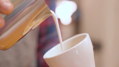 Barista-prepares-flat-white-coffee-with-latte-art-on-surface