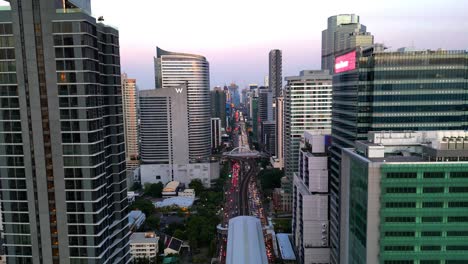 bts skytrain tracks in silom area in bangkok between skyscrapers in the business district