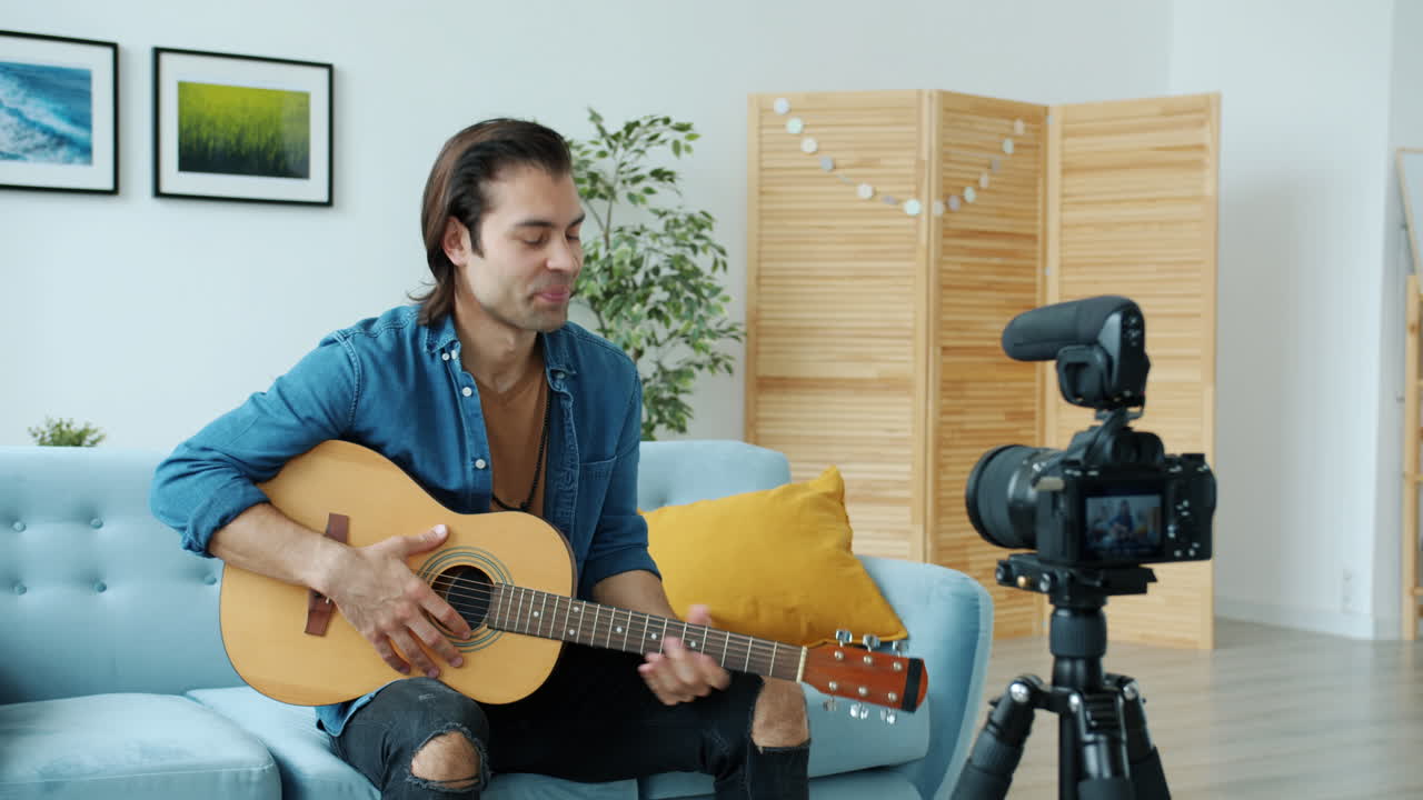 Man playing guitar in a home studio
