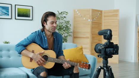 man playing guitar in a home studio