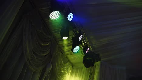 lights flashing on the ceiling of a nightclub. colorful spotlights spinning and glittering during the dance party.