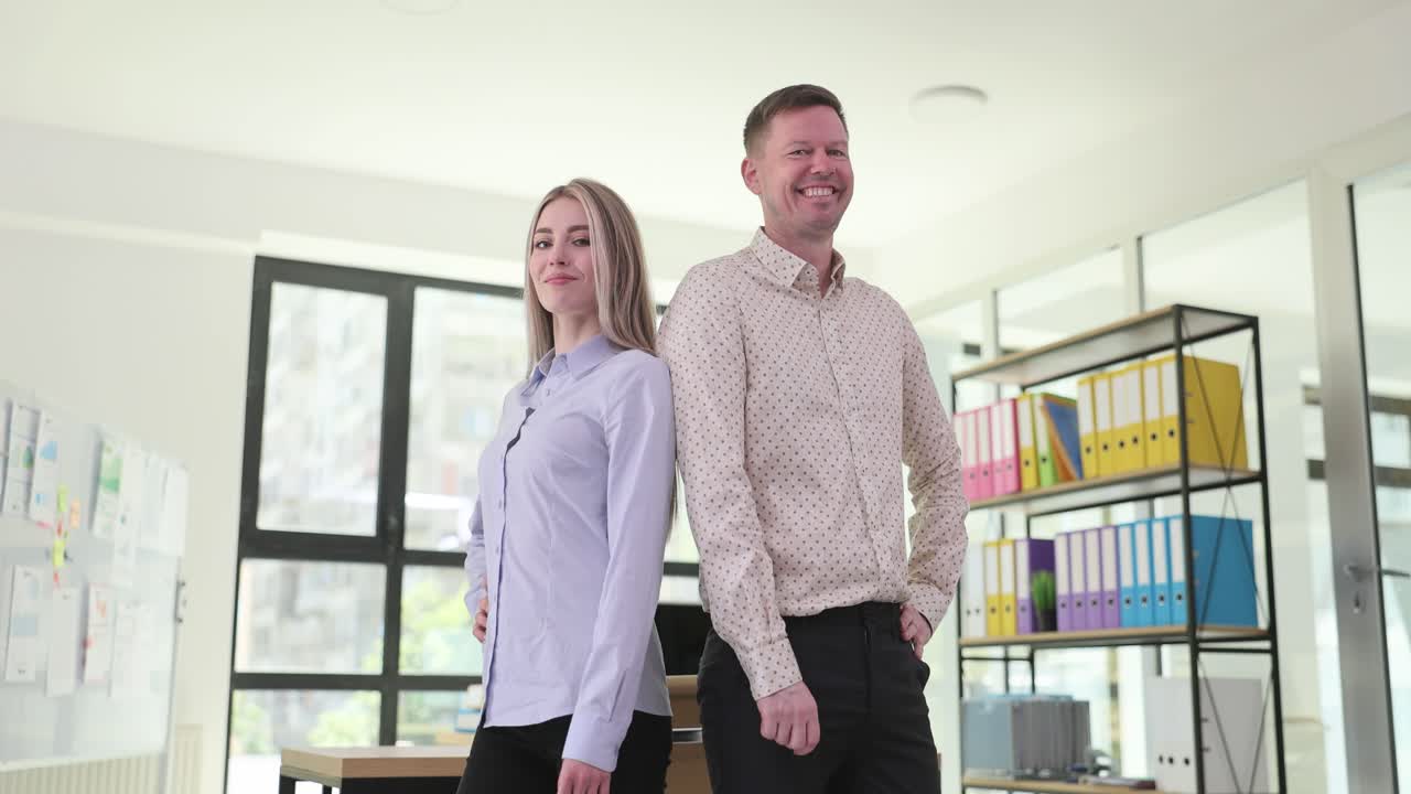 Two Confident Business People Standing in an Office
