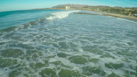 aerial over a generic california coastline with waves breaking 1