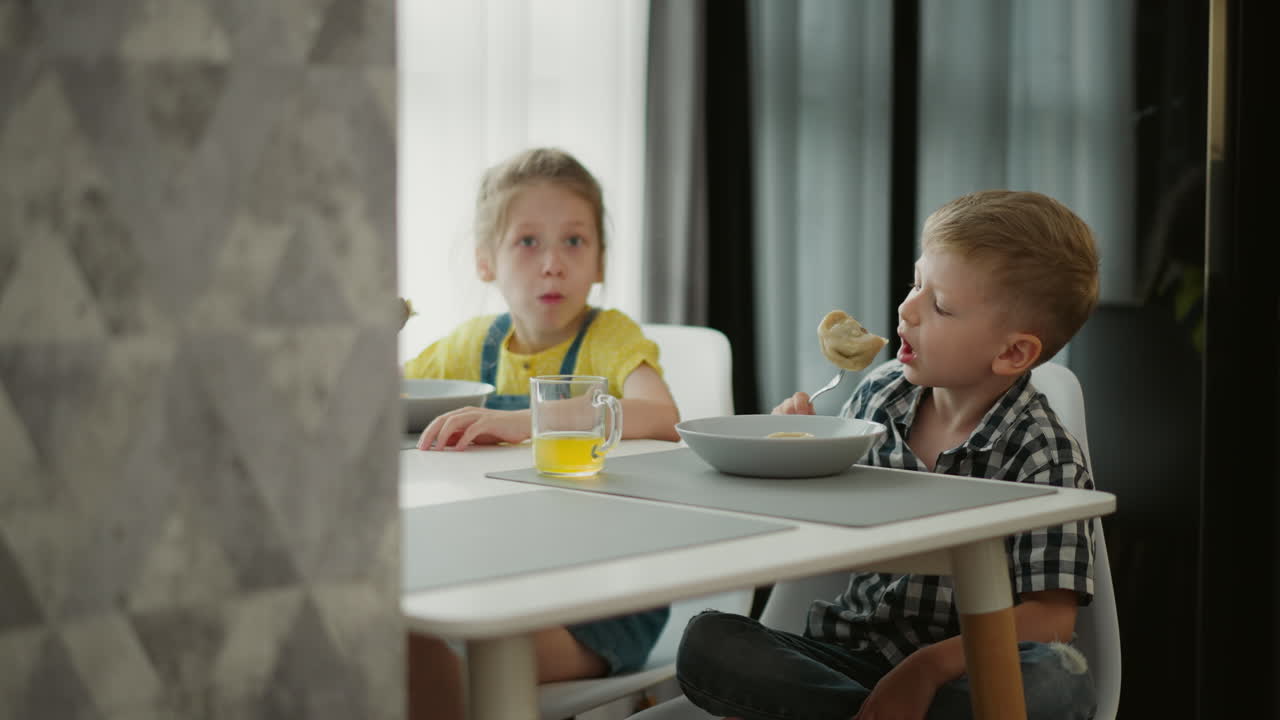 Children eating at a dining table.