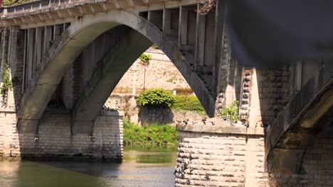 stone arch bridge over calm canal waters